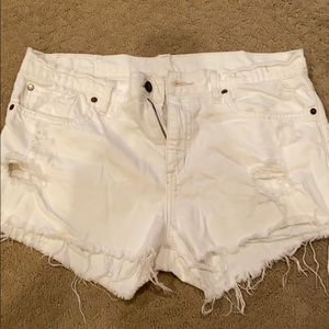 Distressed white jean shorts